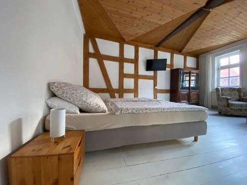 a bedroom with a bed and a table in a room at Haus Anastasia in Stolberg i. Harz