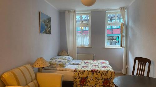 a small bedroom with a bed and a table and chairs at Haus Anastasia in Stolberg i. Harz