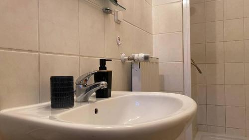 a bathroom sink with a faucet and a mirror at Haus Anastasia in Stolberg i. Harz