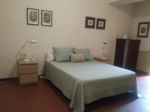 a bedroom with a large bed and a night stand at Alfacs in Sant Carles de la Ràpita