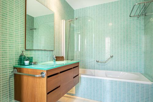 a bathroom with a tub and a sink and a shower at BeGuest Olhão Ria Formosa View in Olhão