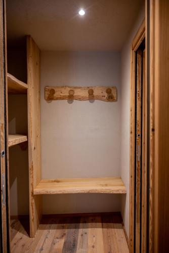 a room with wooden shelves in a room at Residenza dell'Aquila - appartamento in Vezza dʼOglio