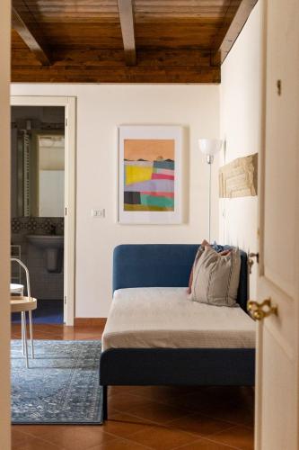 a bedroom with a blue bed in a room at Palazzo della Contessa - Suites & Breakfast in Lecce