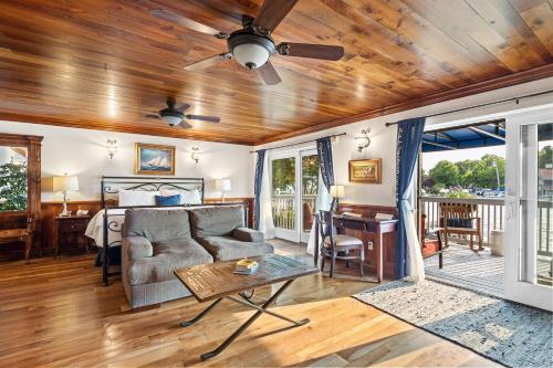a living room with a couch and a ceiling fan at St Michaels Harbour Inn, Marina and Spa in Saint Michaels