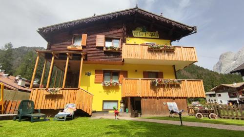 a house with a sign on the front of it at Villa L'Aida in Canazei