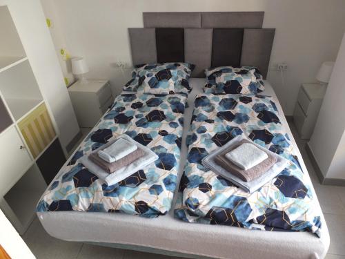 a bed with two pillows on it in a room at Neptuno Playa San Antonio in Cullera