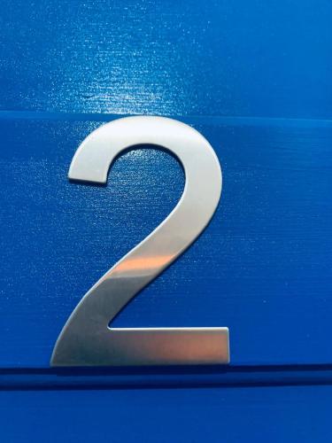 a silver number on the side of a blue car at Limni No 2 self catering apartment in Posidhonía