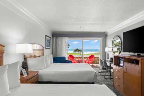 a hotel room with two beds and a television at Beachcomber Motel in Fort Bragg