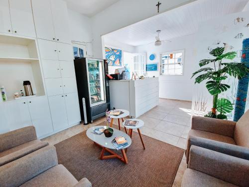 a living room with two couches and a table at Pousada Água Marinha in Cabo Frio