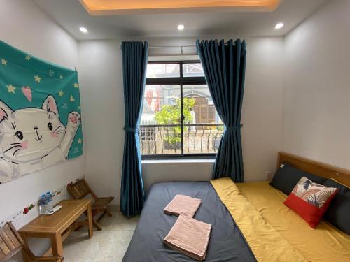 a small bedroom with a bed and a window at Prana Vũng Tàu in Vung Tau