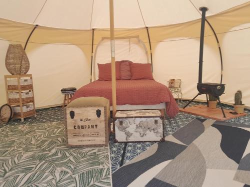 - une chambre avec un lit dans une tente dans l'établissement Auberge la marchadaine, à Montrollet