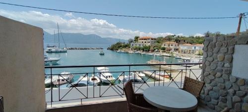 a balcony with a view of a marina with boats at Prego Living Apartments in Vathí