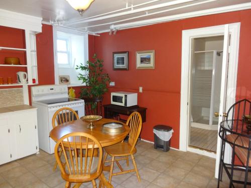 a kitchen with a table and chairs in a room at A Tanners Home Inn Bed and Breakfast in Saint John