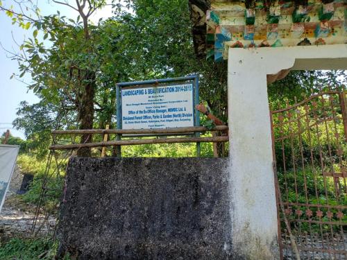 a sign on a fence in front of a tree at DOOARS VELLEY HOME STAY in Buxa Duār