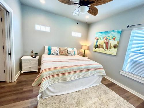 a bedroom with a bed and a ceiling fan at SeaKing Relaxation where the waves meet the shore and time slows down in Port Aransas