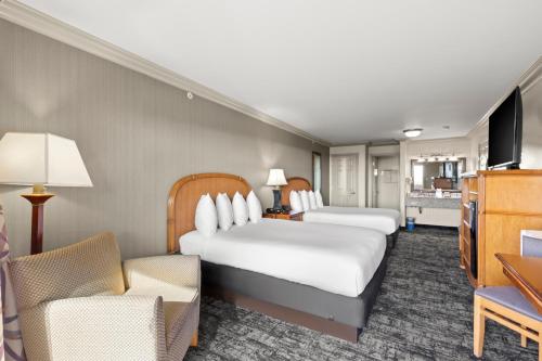 a hotel room with two beds and a flat screen tv at Surf and Sand Lodge in Fort Bragg