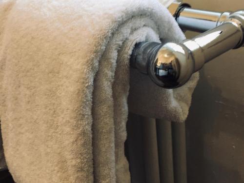 a towel hanging from a towel rack with a radiator at Westwood House in Dorchester