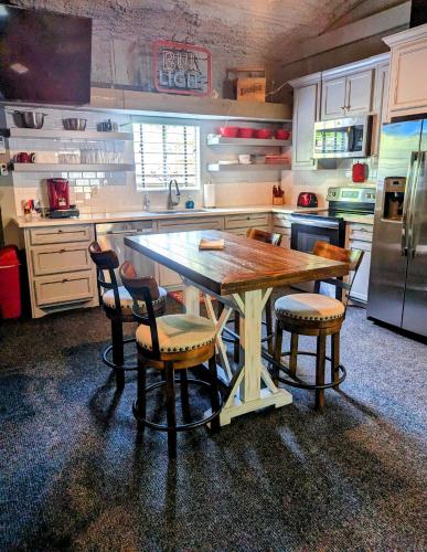 a kitchen with a large wooden table and chairs at Cozy Barn with Pool Access & Near Lake Conroe in Montgomery