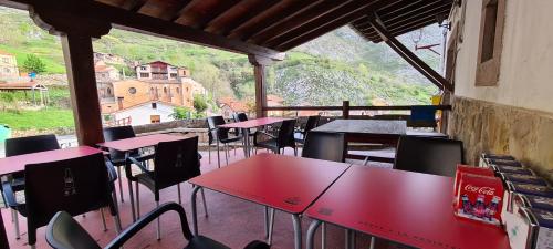 a group of tables and chairs in a room at Taberna de Tresviso in Tresviso