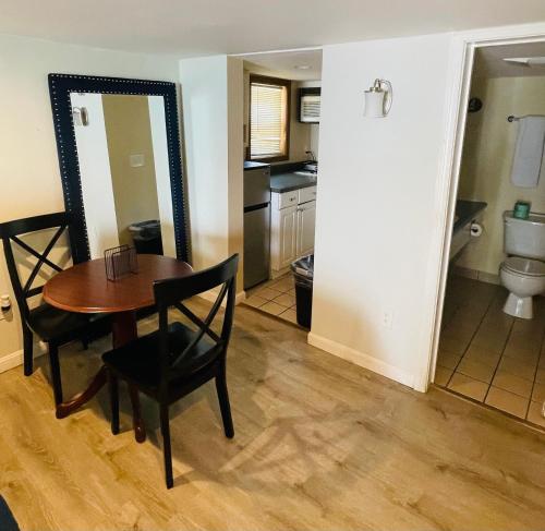 a dining room with a table and chairs and a kitchen at Ships Inn in Hampton