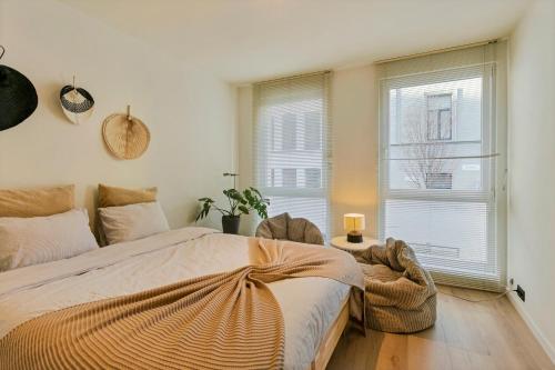 a bedroom with a large bed and a window at New renovated condo's @ trendy south in Antwerp