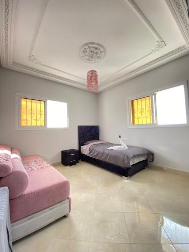 a bedroom with two beds and a ceiling with windows at Vila Haja - Beautiful Farmhouse with a Private Pool! in Imouzzer Kandar