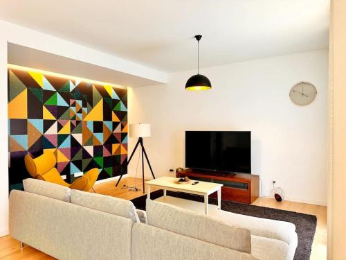 a living room with a couch and a tv at Lucky Alameda Apartment in Lisbon