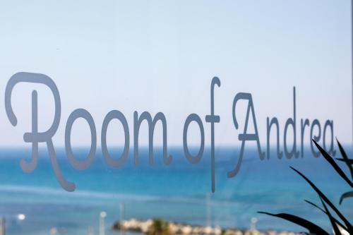 a sign for the town of naples in front of the ocean at Room Of Andrea Hotel in Trapani