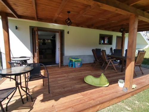 a wooden deck with a table and chairs on it at Noclegi na Wygonie in Sromowce Niżne