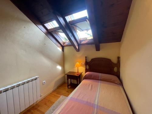 ein kleines Schlafzimmer mit einem Bett und Oberlichtern in der Unterkunft E06 - Casa Carmen en Eriste - Villmor in Eriste