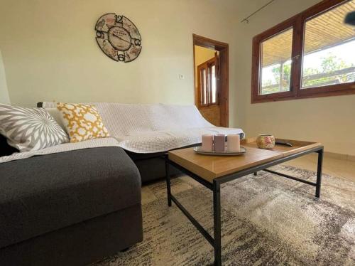 a living room with a couch and a coffee table at A Home away from Home in Psakoudia