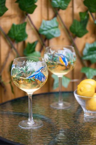 a couple of wine glasses sitting on a table at Cottage - Sleeps 3 hot tub & pet friendly in Brampton