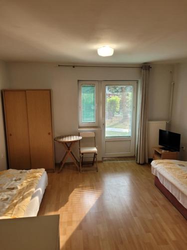 a room with two beds and a table and a window at Rozalia in Wisełka