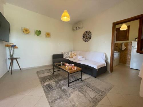 a living room with a couch and a coffee table at A Home away from Home in Psakoudia