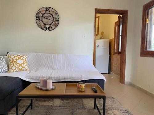 a living room with a couch and a coffee table at A Home away from Home in Psakoudia