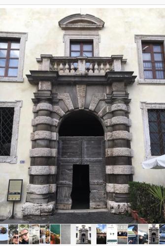 an entrance to a building with a wooden door at La Casa di Clara nella Rocca in Farnese