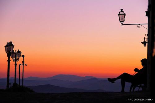 a person sitting on a horse in front of a sunset at Case Ruggieri Luxury apt - Don Pietro in Gratteri