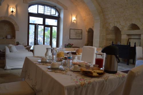 a table with food and drinks on it in a room at Palazzo Vecchio in Marittima