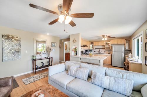 a living room with a couch and a ceiling fan at Hale Kahana'lu condo in Koloa