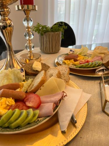 a table with two plates of different types of food at La Rose Residence in Mikołajki