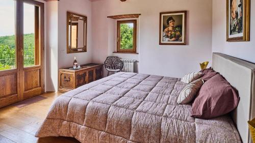 a bedroom with a large bed and a window at Cielo di Radda in Radda in Chianti
