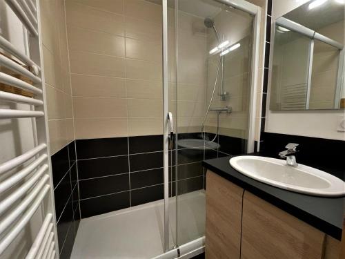 une salle de bain avec douche et lavabo dans l'établissement Beau 2 pièces cabine au pied des pistes avec balcon, animaux bienvenus - FR-1-452-153, aux Menuires
