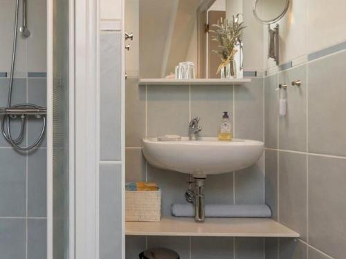 a bathroom with a sink and a mirror at Chambre tout confort près du canal à Blain, accès handicapés, WiFi, TV, coin cuisine - FR-1-306-1255 in Blain