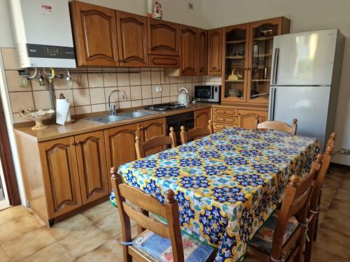 a kitchen with a table and a refrigerator at Omary in Colà di Lazise