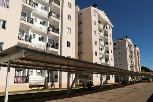 a bridge in front of two tall buildings at Curta Praia do Quilombo - Palladium in Penha