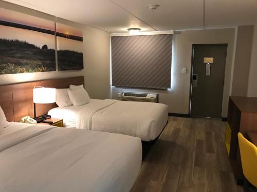 Ένα ή περισσότερα κρεβάτια σε δωμάτιο στο Days Inn by Wyndham Vineland