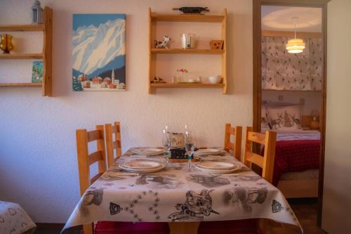 a dining room table with a table cloth on it at Le Rossane 26m Balcon vue in Aillon-le-Jeune
