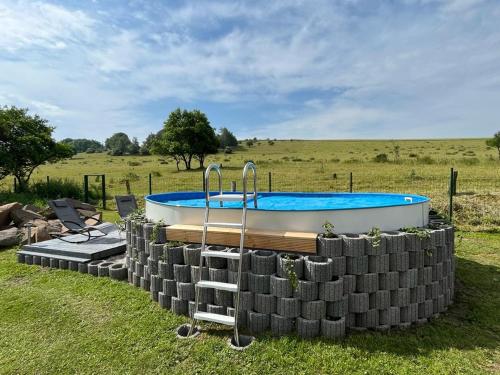 a pool in a stack of tires next to a field at Apartmant u Bukové Hory in Verneřice
