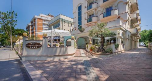 a building on a street next to a sidewalk at Parco dei Principi Boutique Hotel in Rimini