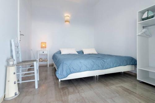 a bedroom with a bed and a ladder in it at Villa Big Blue in Mavrovoúnion